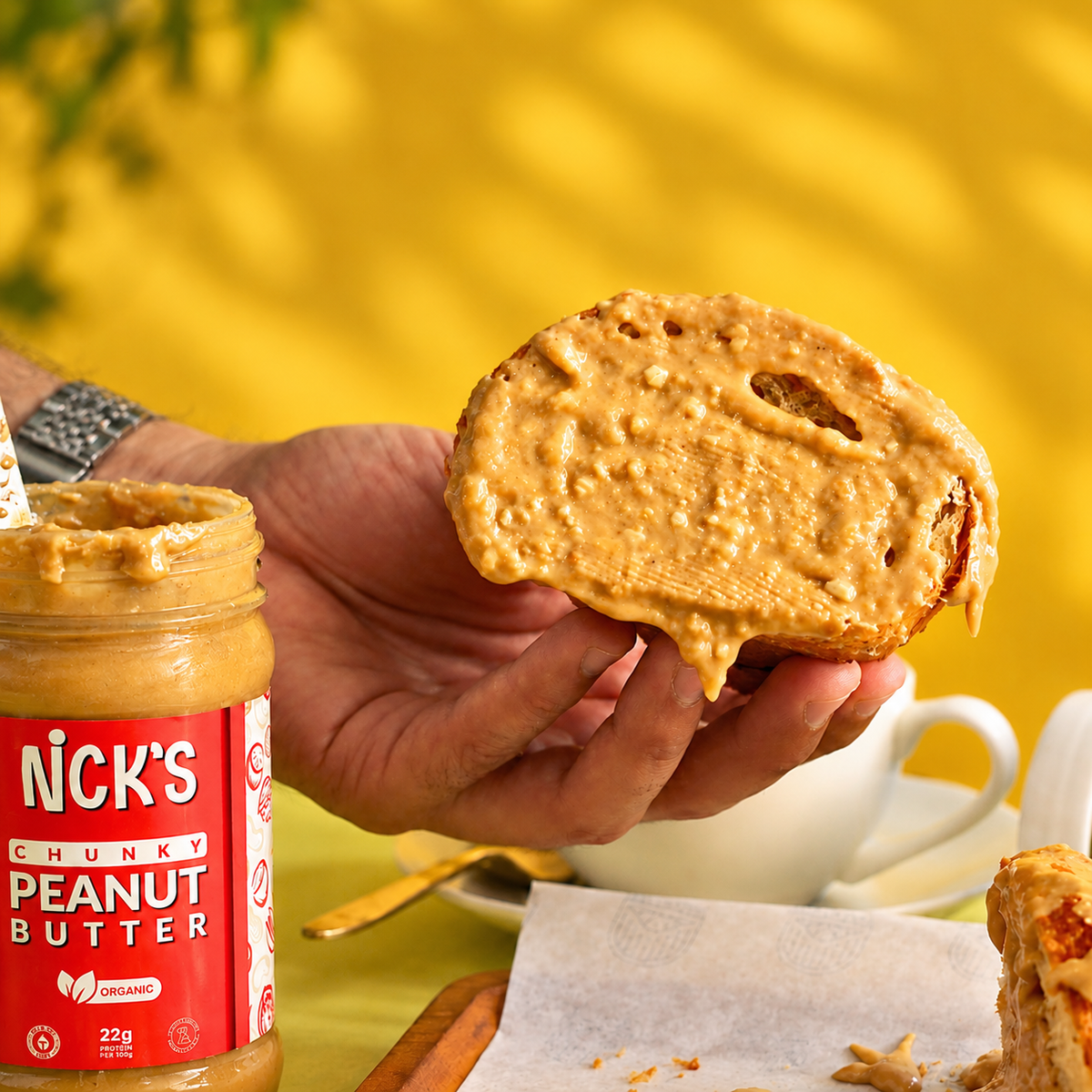 Close-up of bread thickly spread with NICK'S chunky peanut butter